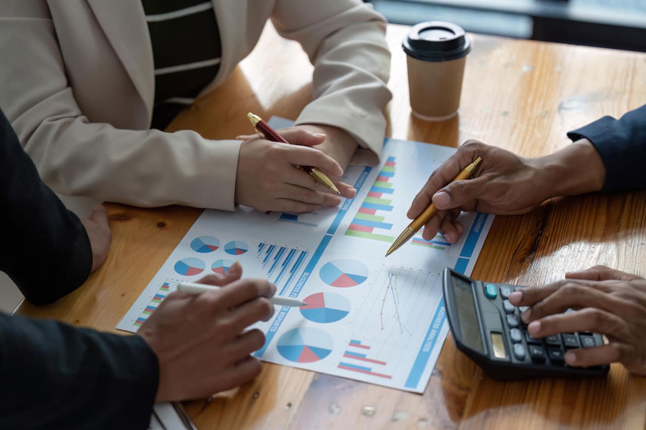 Professionals analyzing financial charts and graphs as part of financial planning for uncertainty.